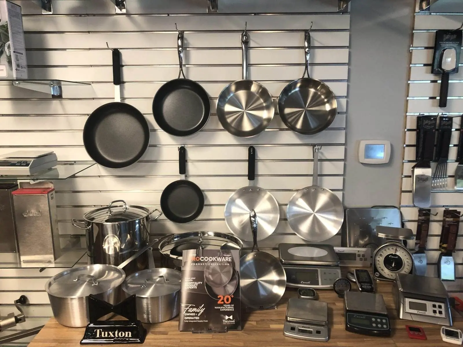 Cookware and smallwares on a showroom wall