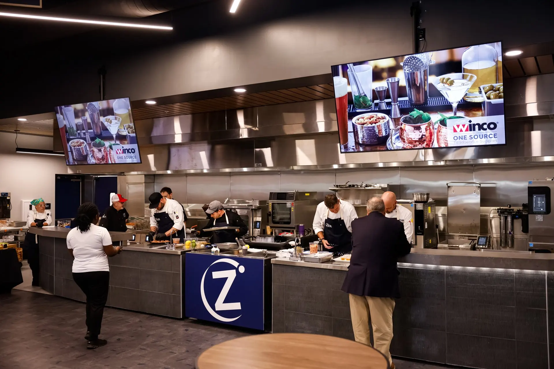 An event in a Zink culinary center — chefs cooking, guests at the counter