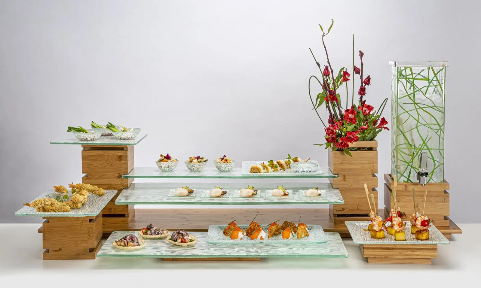 A tiered white porcelain buffet display with small bites