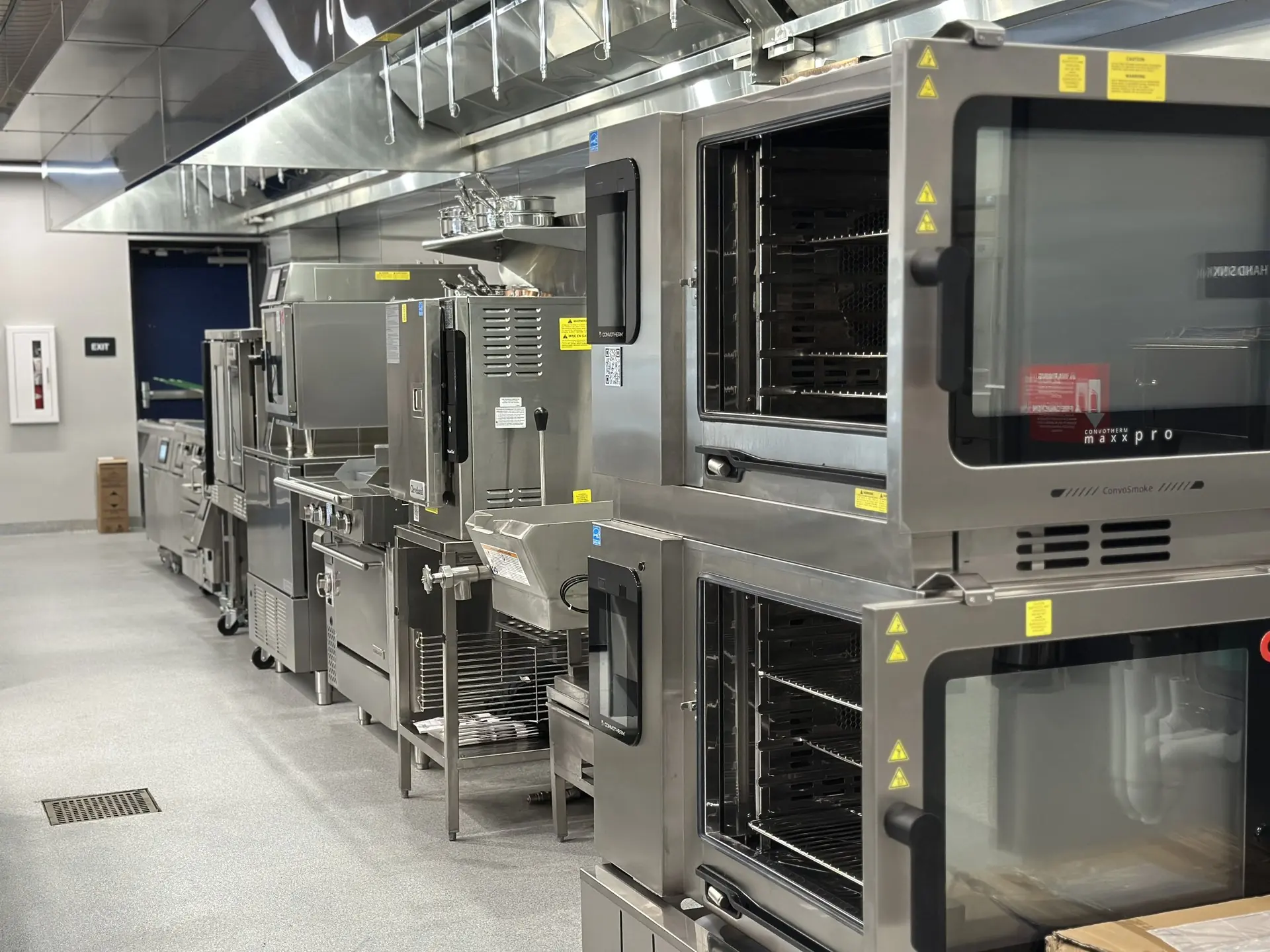 A row of combi ovens on a Zink culinary center demo floor